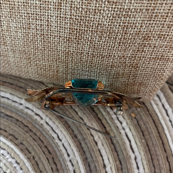 vintage yellow and rose gold-plated aqua rhinestone brooch, circa 1940.